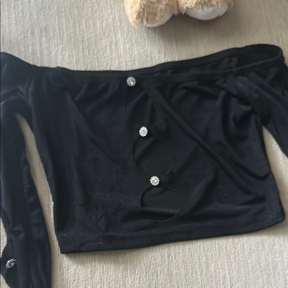 Elegant Top with open features on arms and crystal accents.